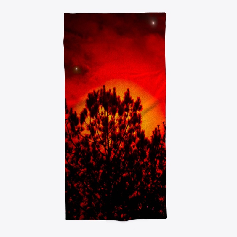 red moon behind trees 