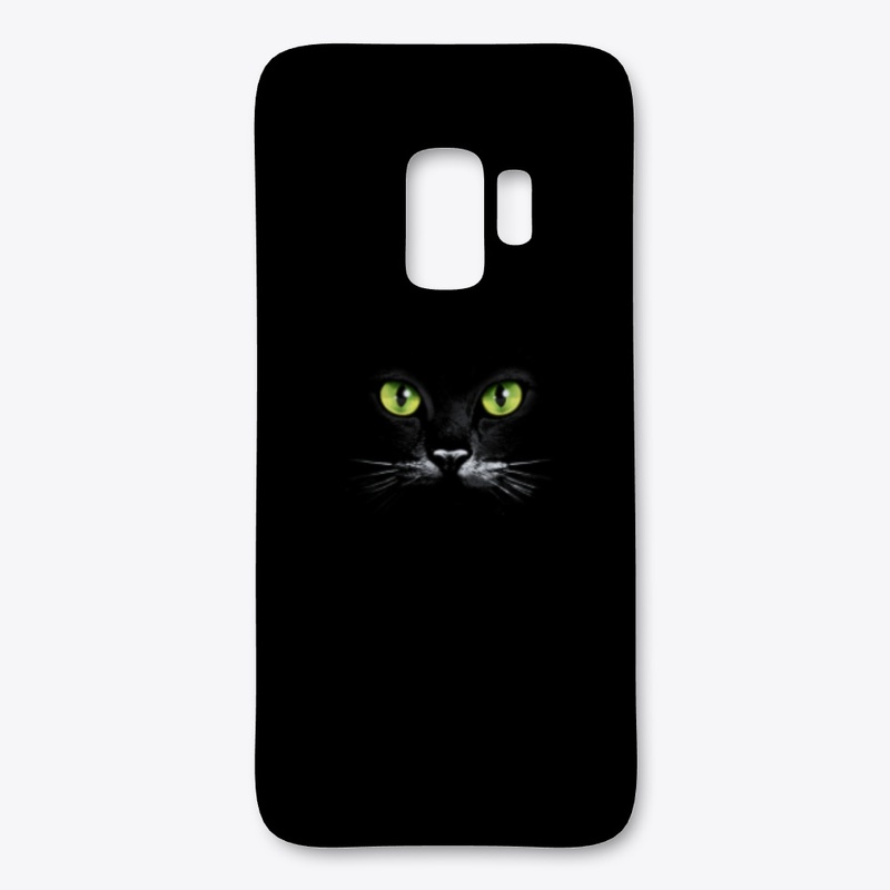 Green eyes of a black cat
