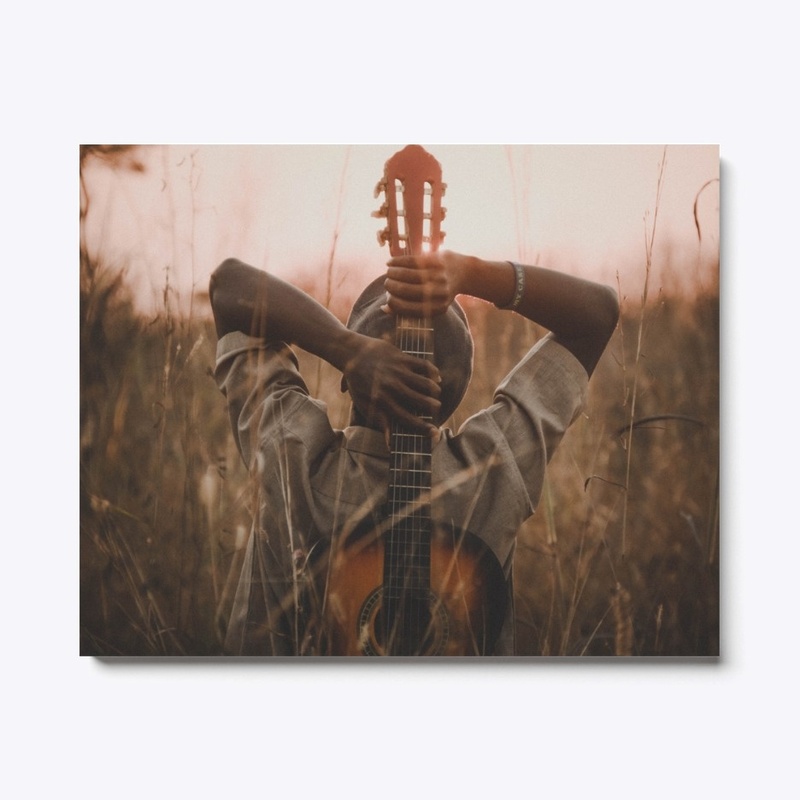 Person with a guitar on a wheat field