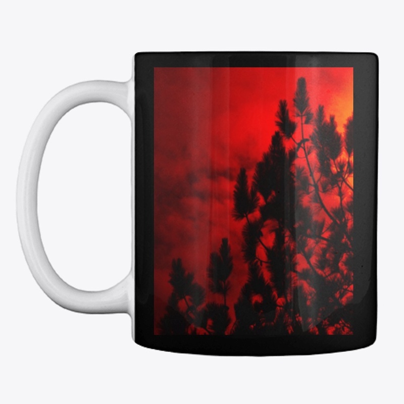 red moon behind trees 